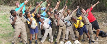 Projects Abroad volunteers posing with Jamaican kids Volunteers and students posing for a picture before their soccer practice
